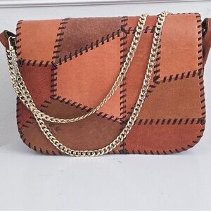 "Patricia Nash patchwork brown leather purse with unbranded chain."